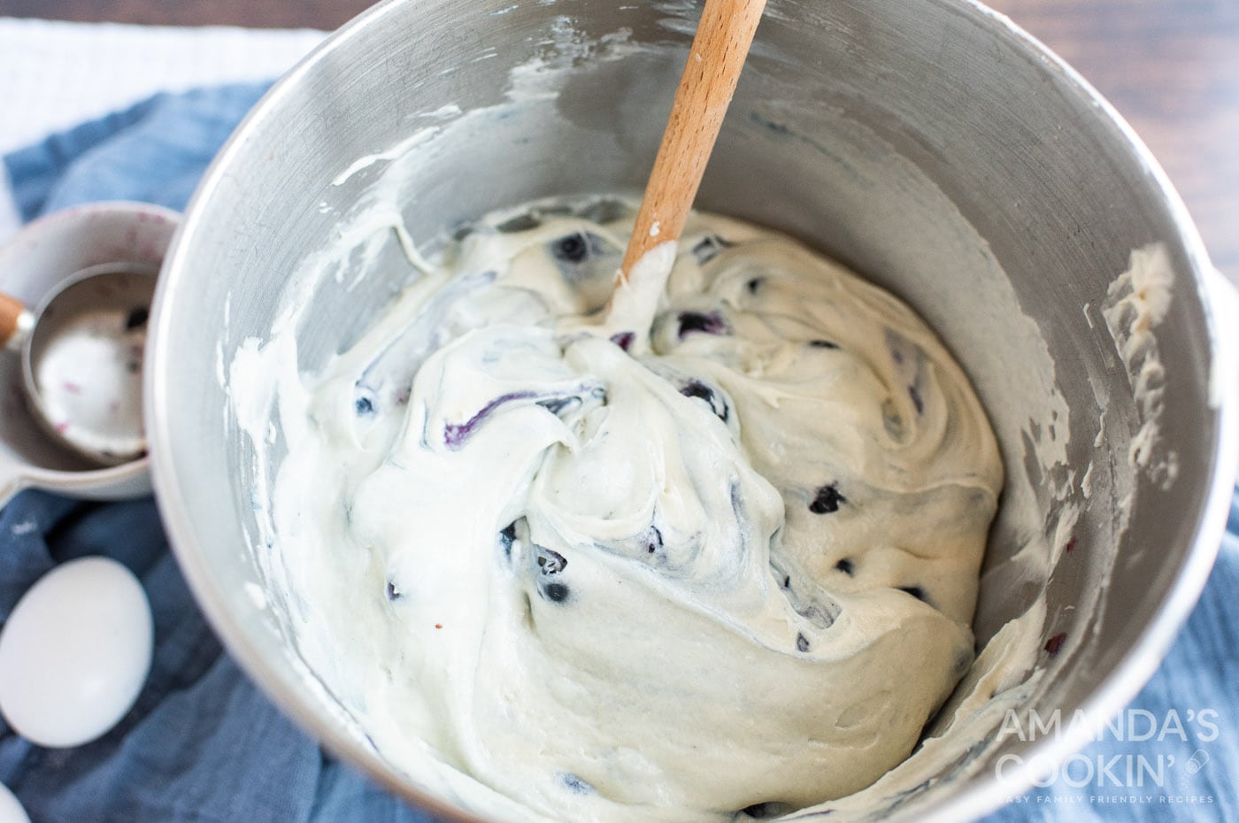 stirring blueberries into cake batter