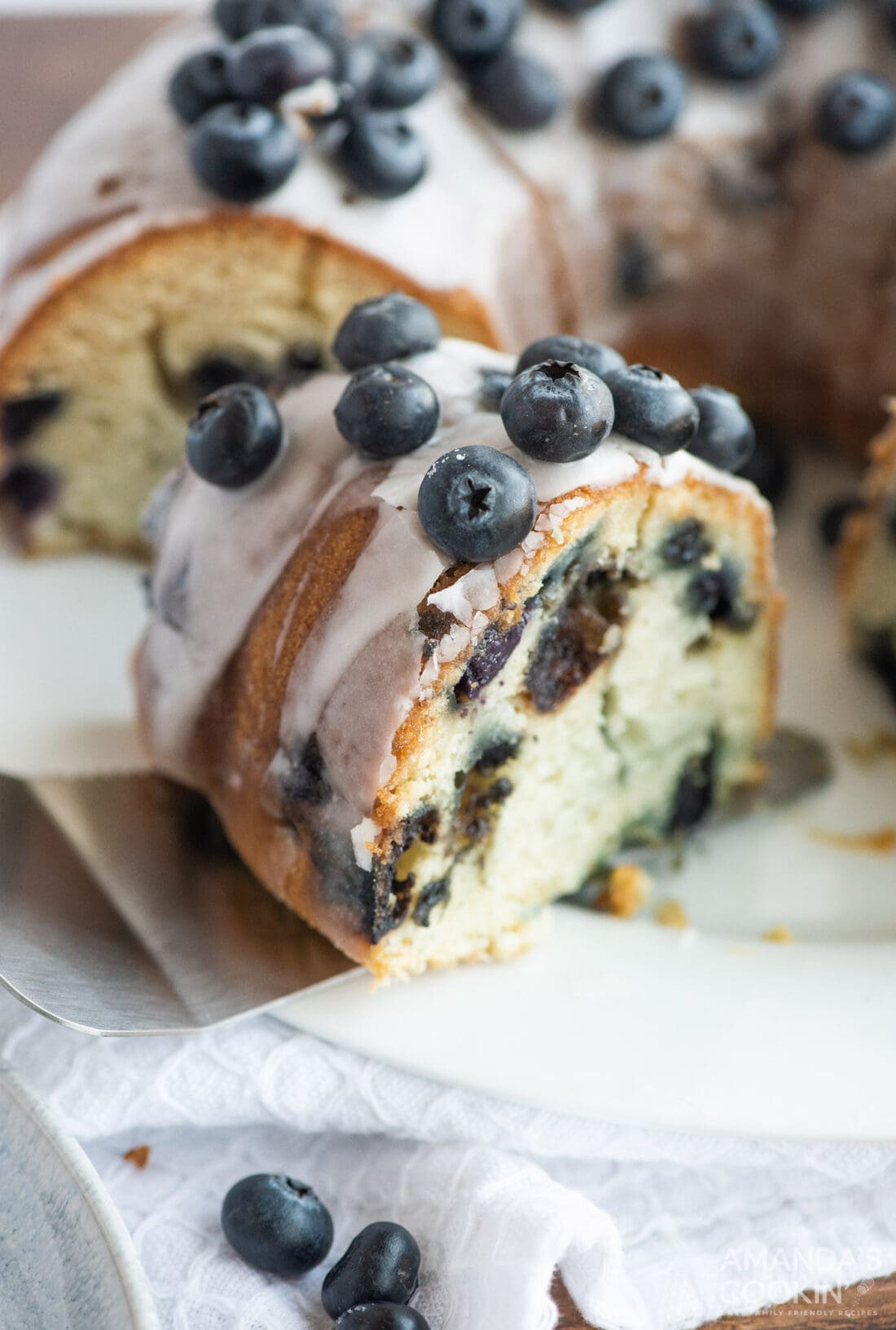 removing slice of Blueberry Bundt Cake from plate