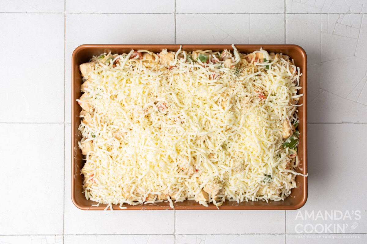 shredded cheese on top of chicken spaghetti casserole