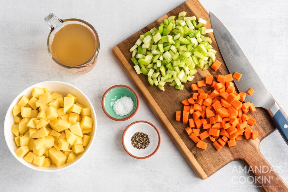 Chopped carrots, celery and potatoes with salt pepper and broth to the side