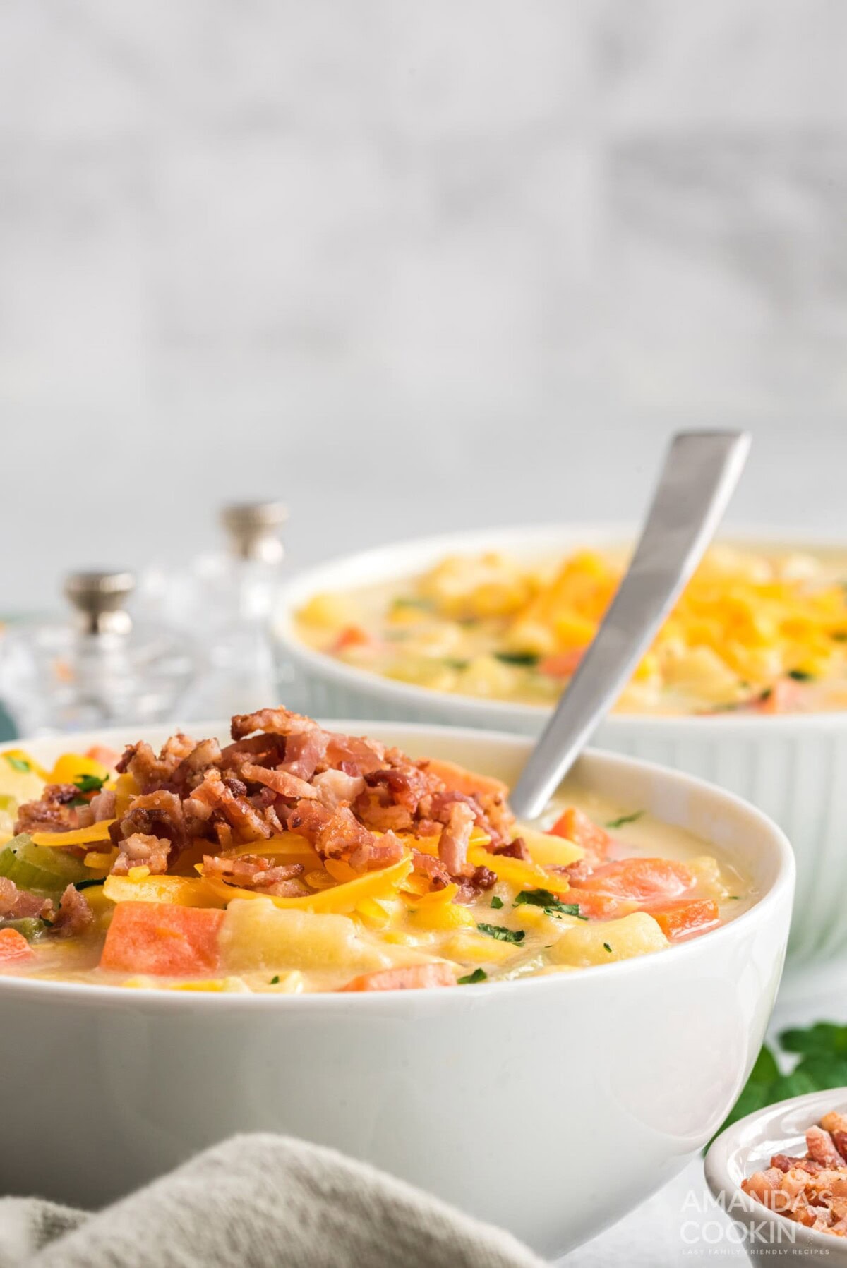 bowl of corn chowder soup with a spoon in it