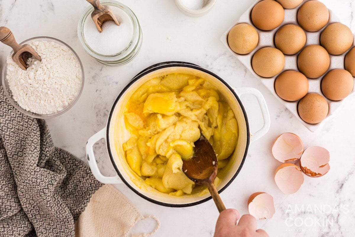 dough in a saucepan with wooden spoon