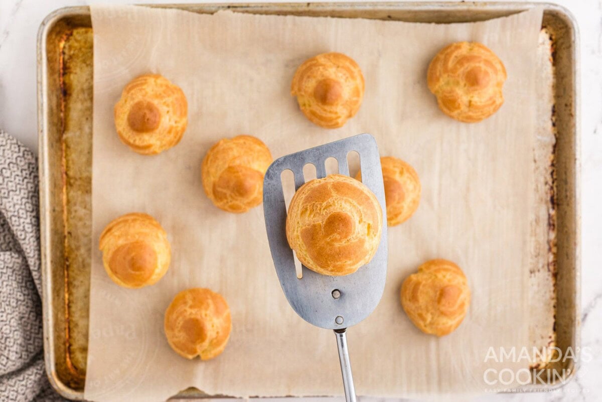 golden brown choux pastry on spatula