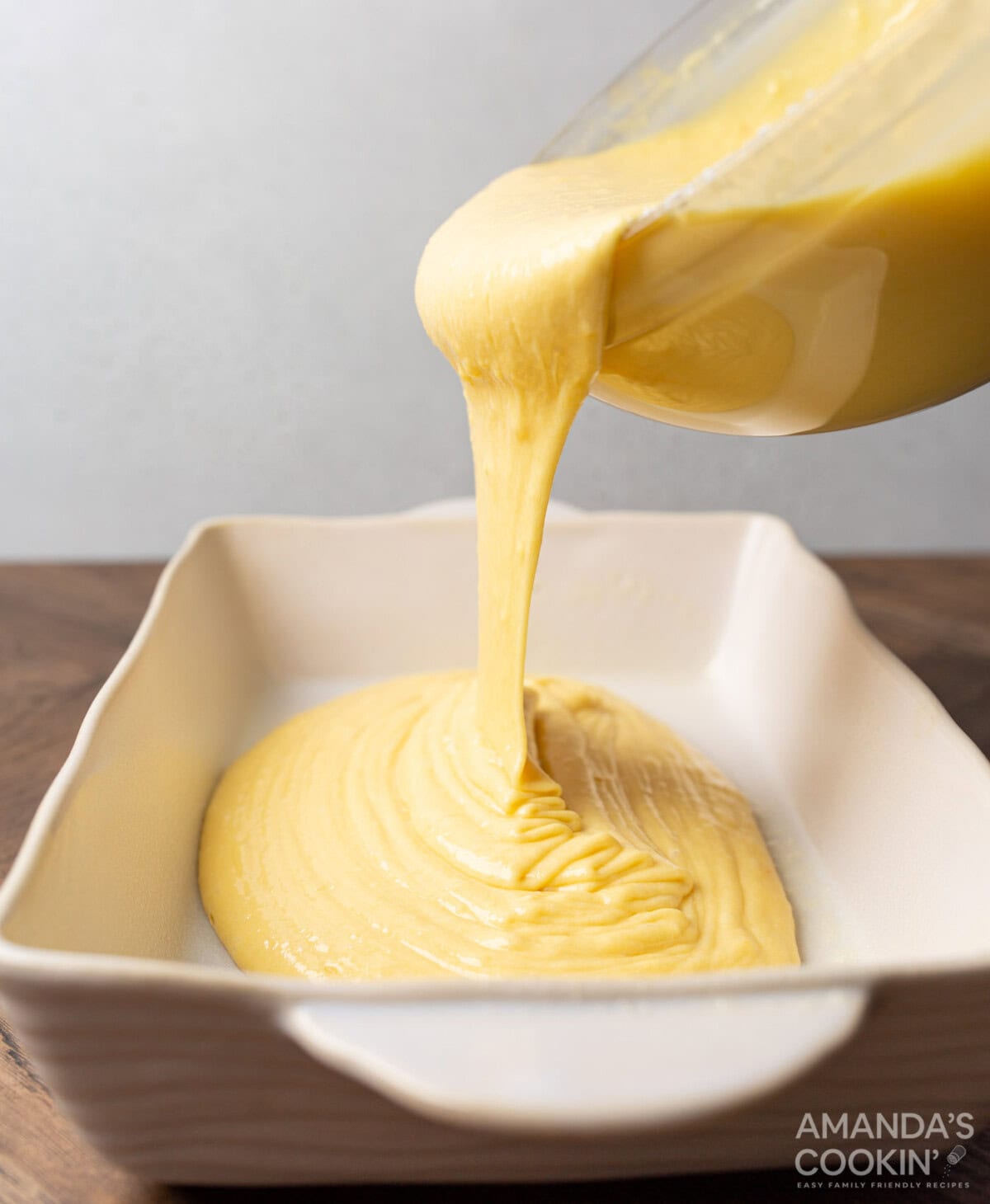 pouring cake batter into pan