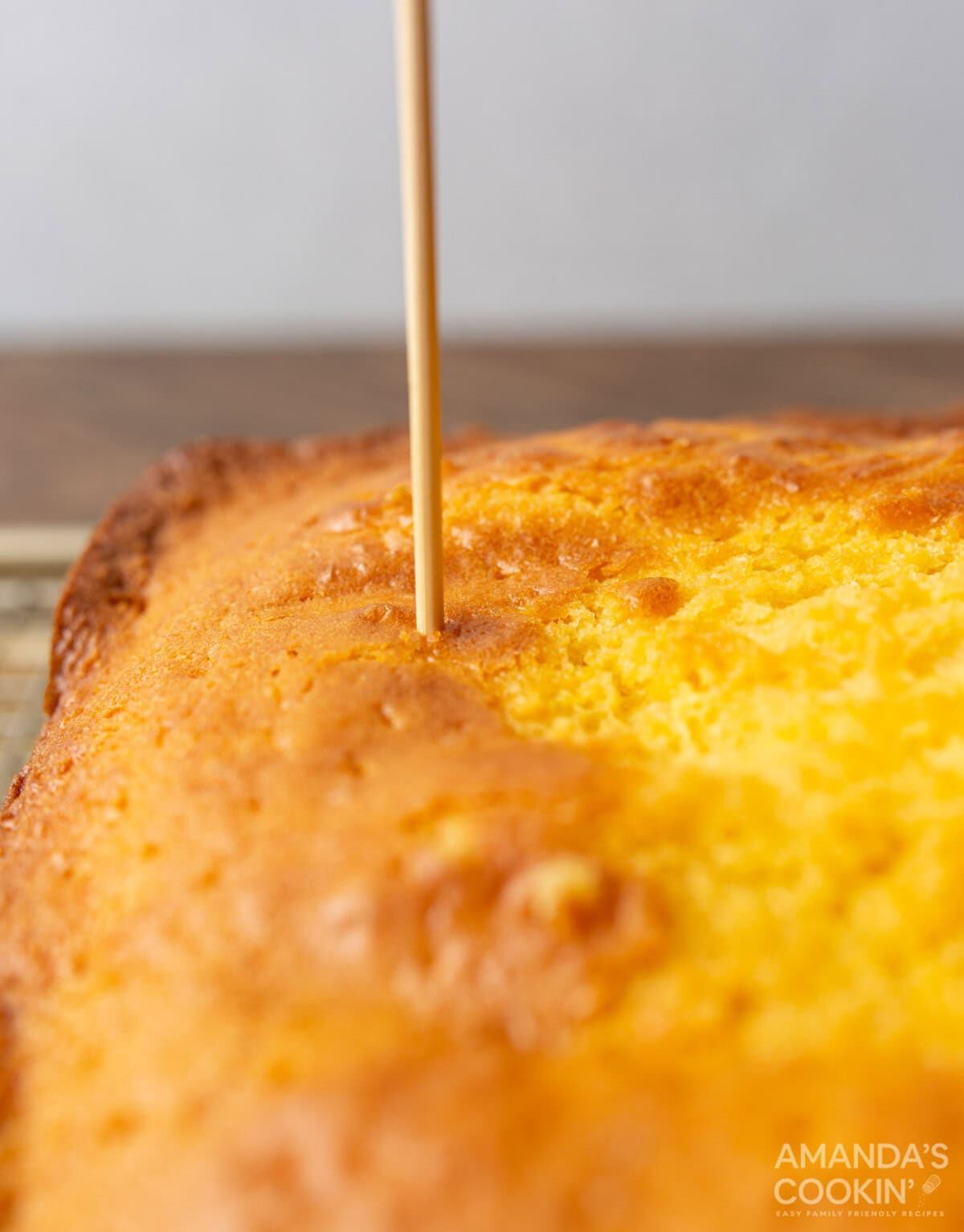 dowel poking cake creating a hole