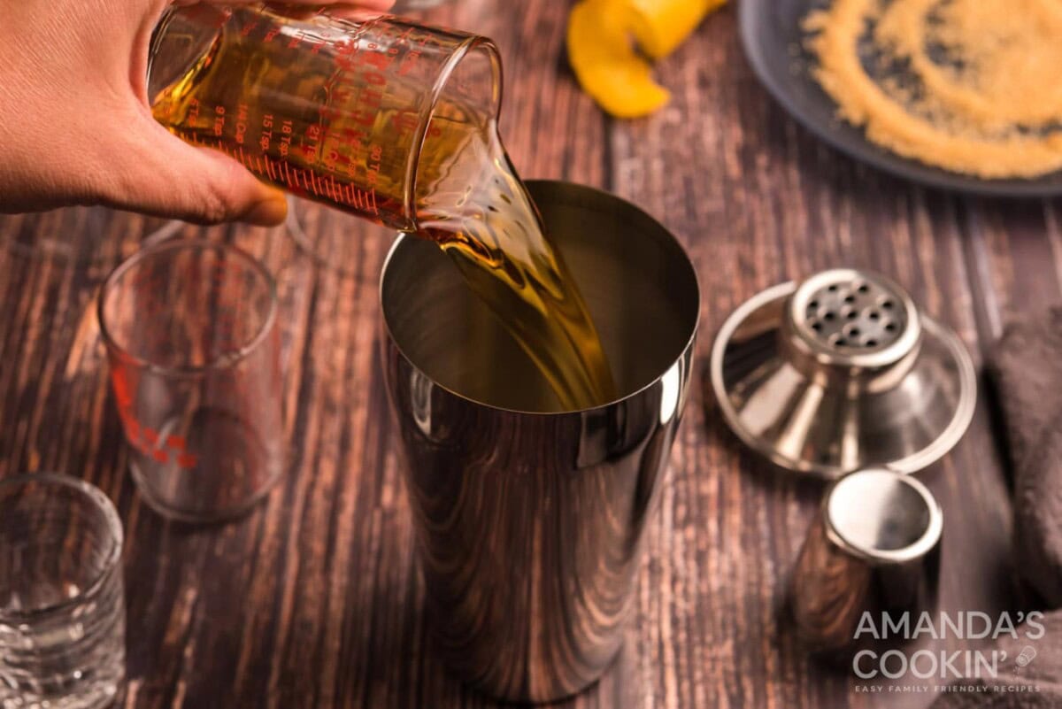 pouring cognac into cocktail shaker