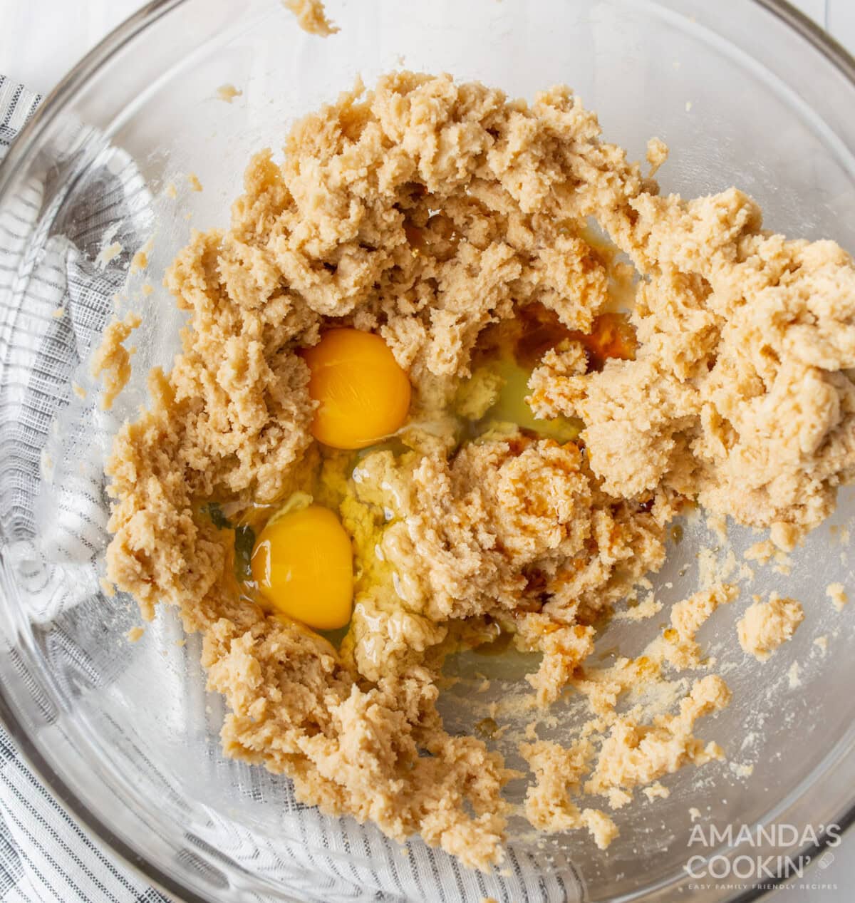 cookie dough batter in a mixing bowl with eggs