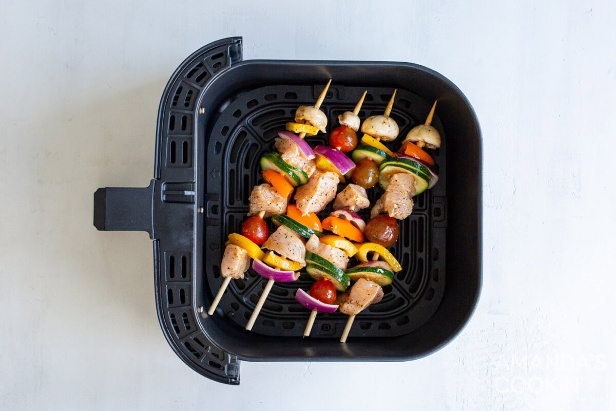 chicken kabobs in an air fryer basket