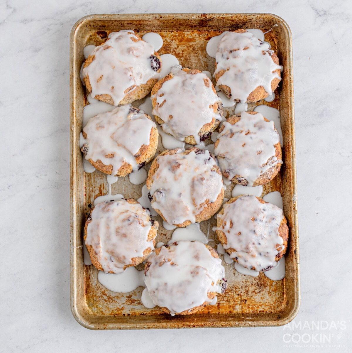 glazed blackberry scones on baking sheet