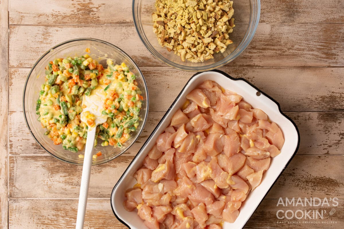 diced chicken in a casserole dish with veggies and stuffing