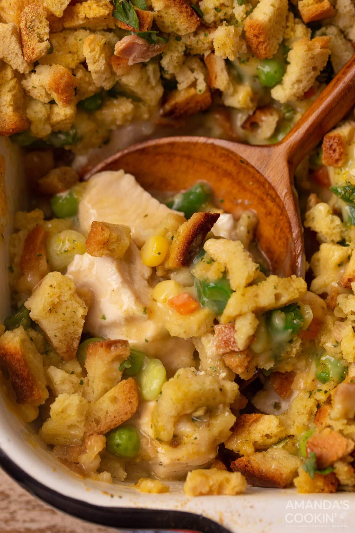 wooden spoon in dish of Chicken Stuffing Casserole