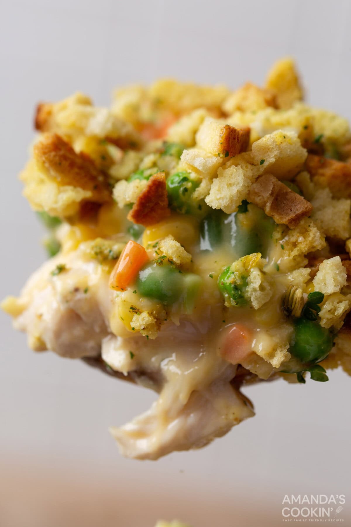 serving spoon of Chicken Stuffing Casserole