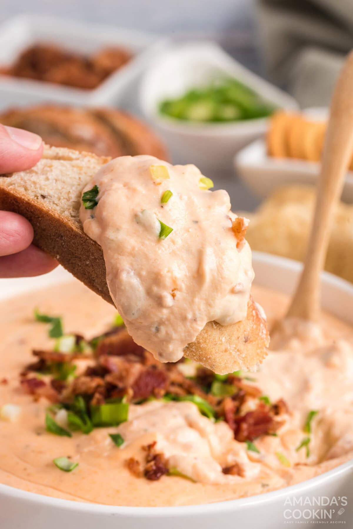 dipping bread in Crockpot Cheese Dip