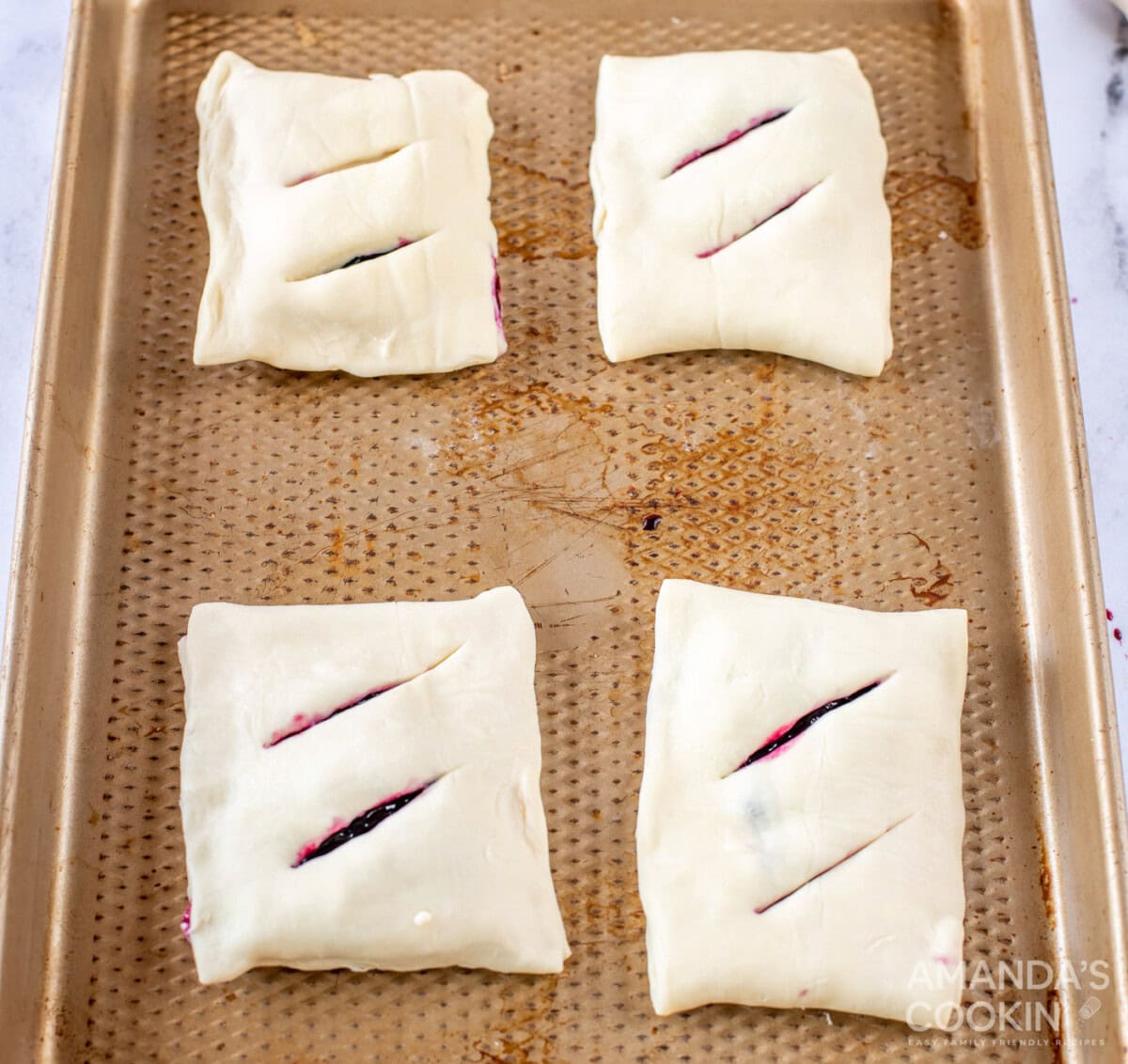 lemon blueberry hand pies on a baking sheet
