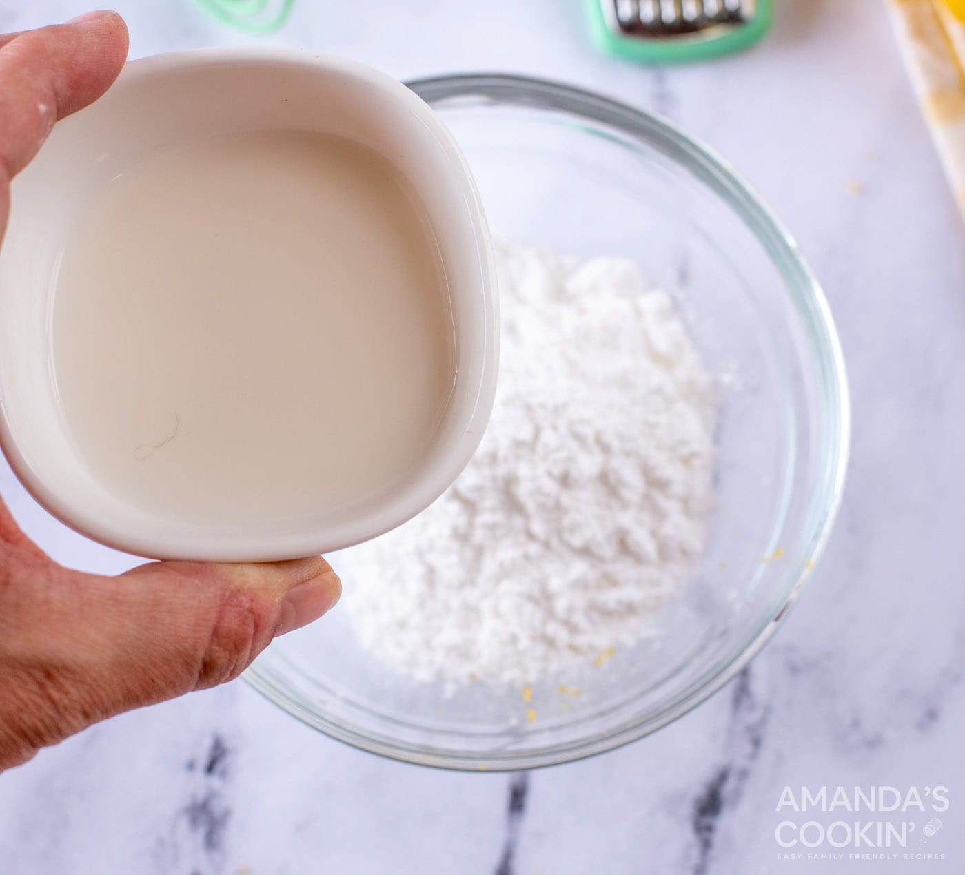 pouring milk into powdered sugar
