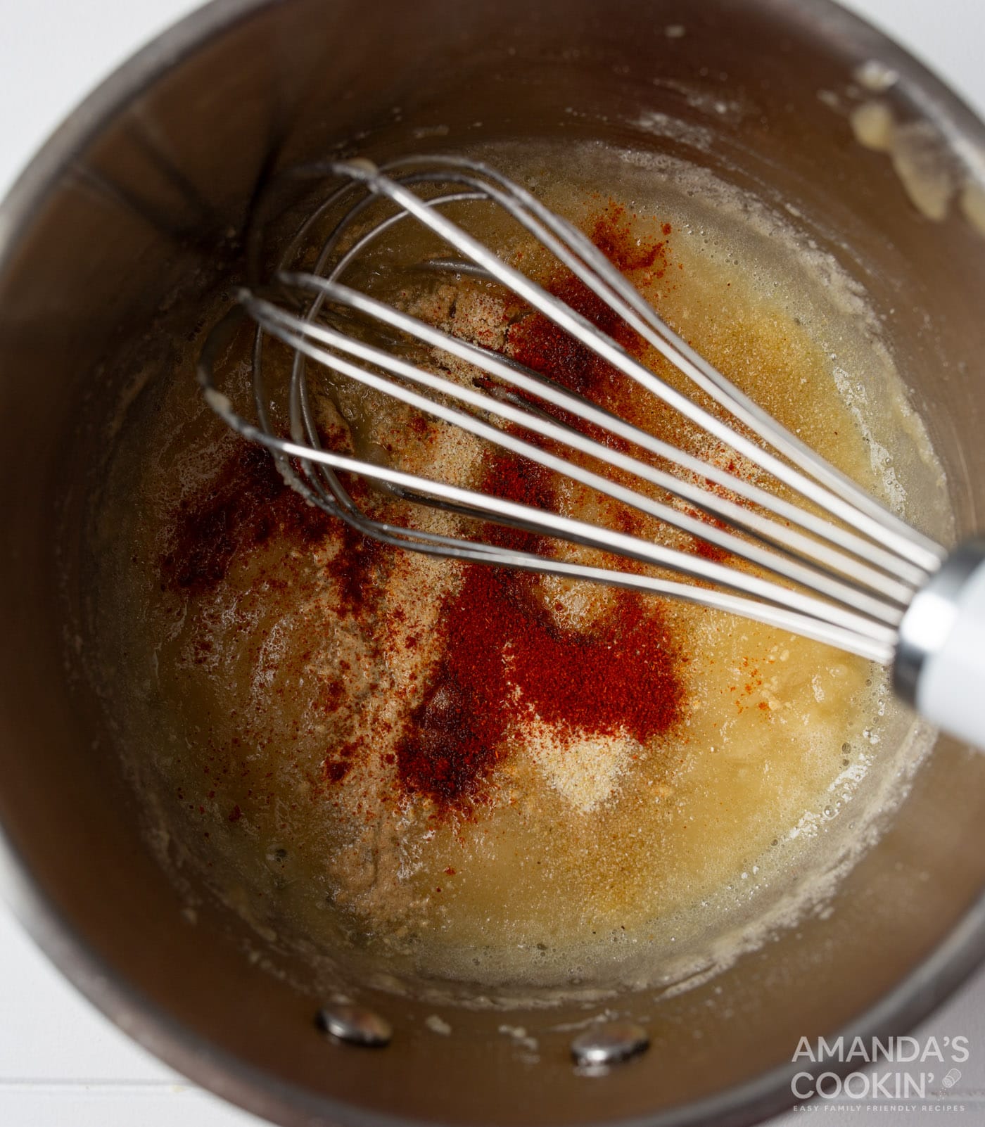 whisking spices into butter and flour roux