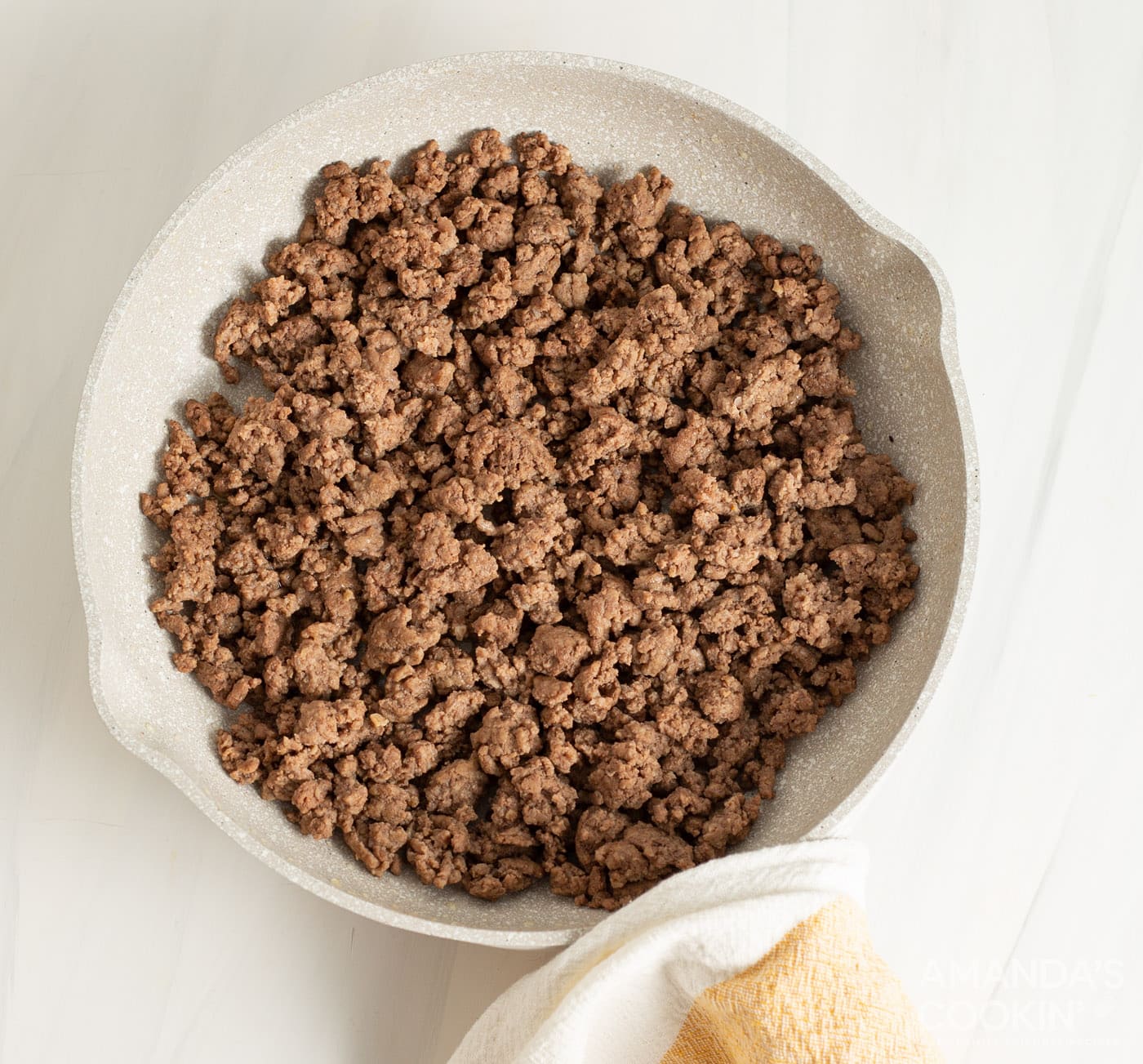 browned ground beef in a strainer