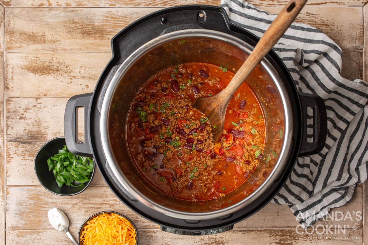 chili in the instant pot with wooden spoon