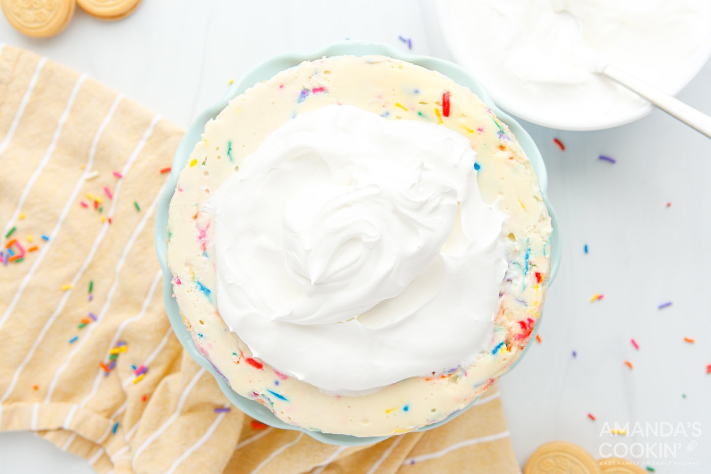 whipped cream dollop on top of funfetti cheesecake