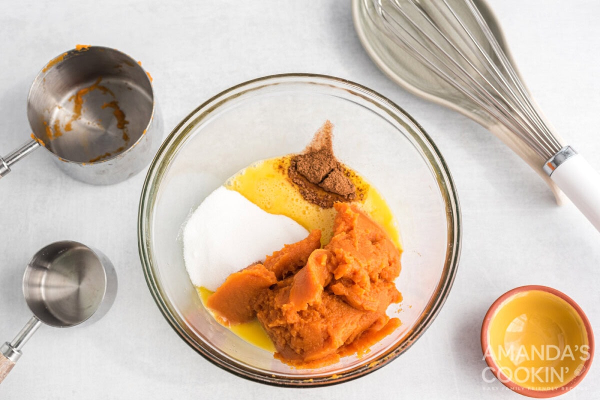 pumpkin, sugar, egg, and pumpkin spice in a bowl