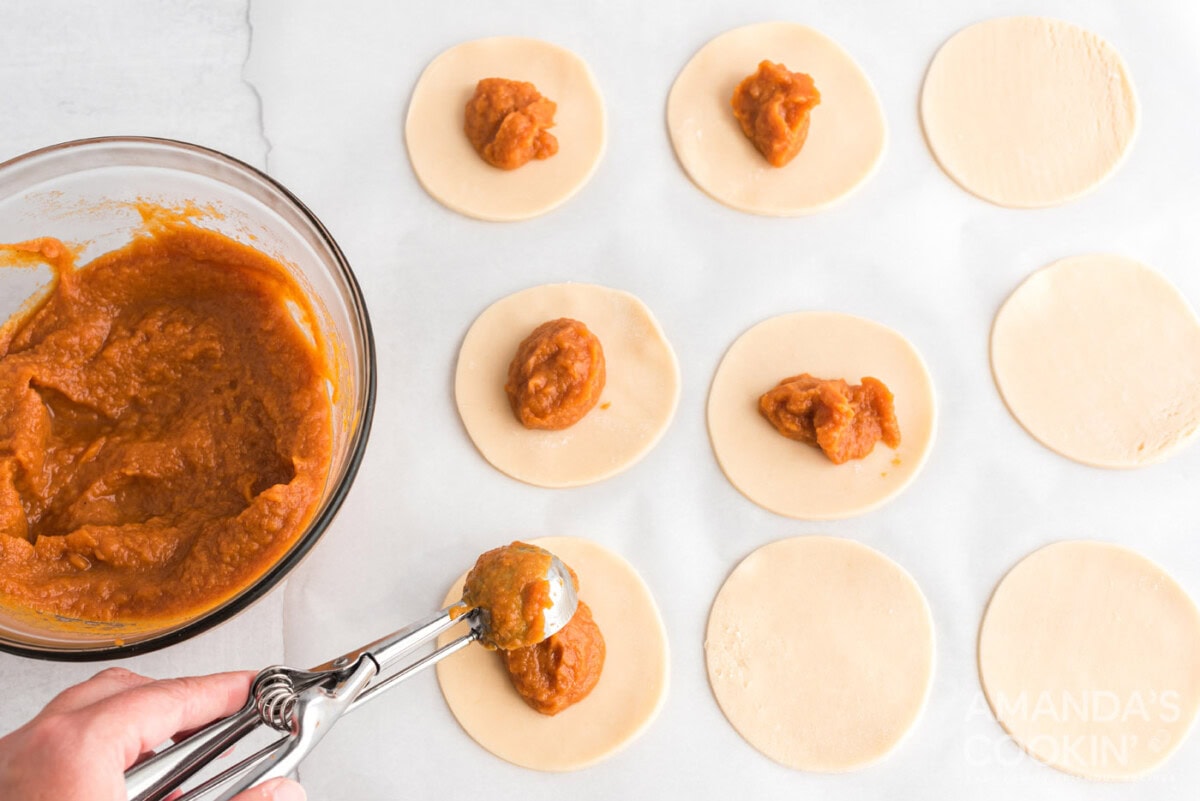 pumpkin pie filling on top of dough discs