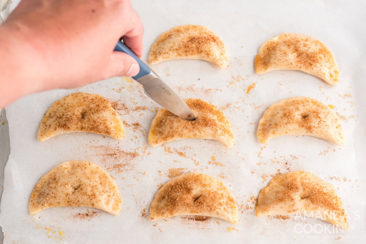 cutting a hole on top of pumpkin hand pies