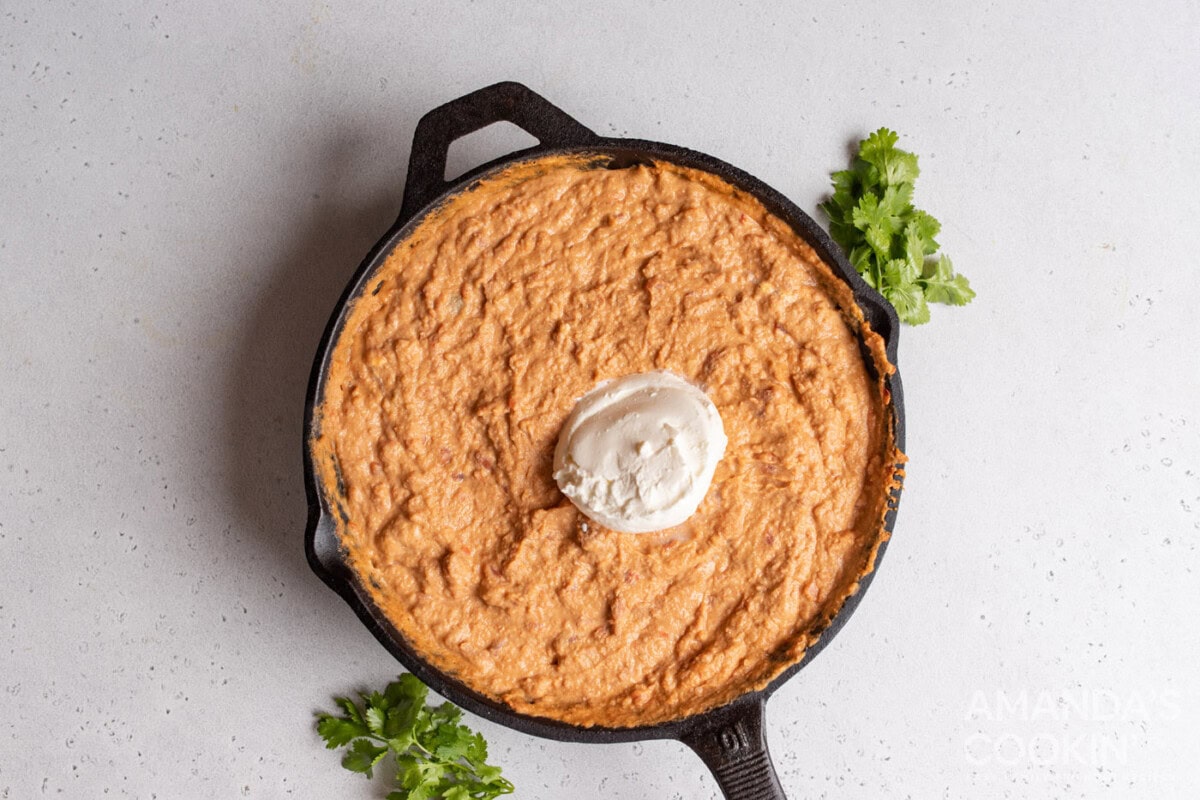 bean dip with sour cream in a skillet