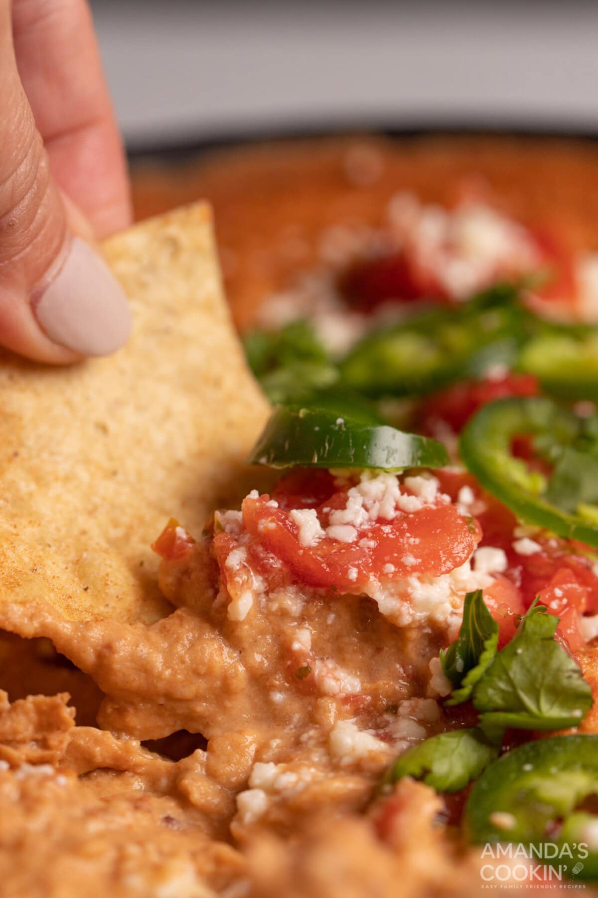 scoping Bean Dip with nacho chip