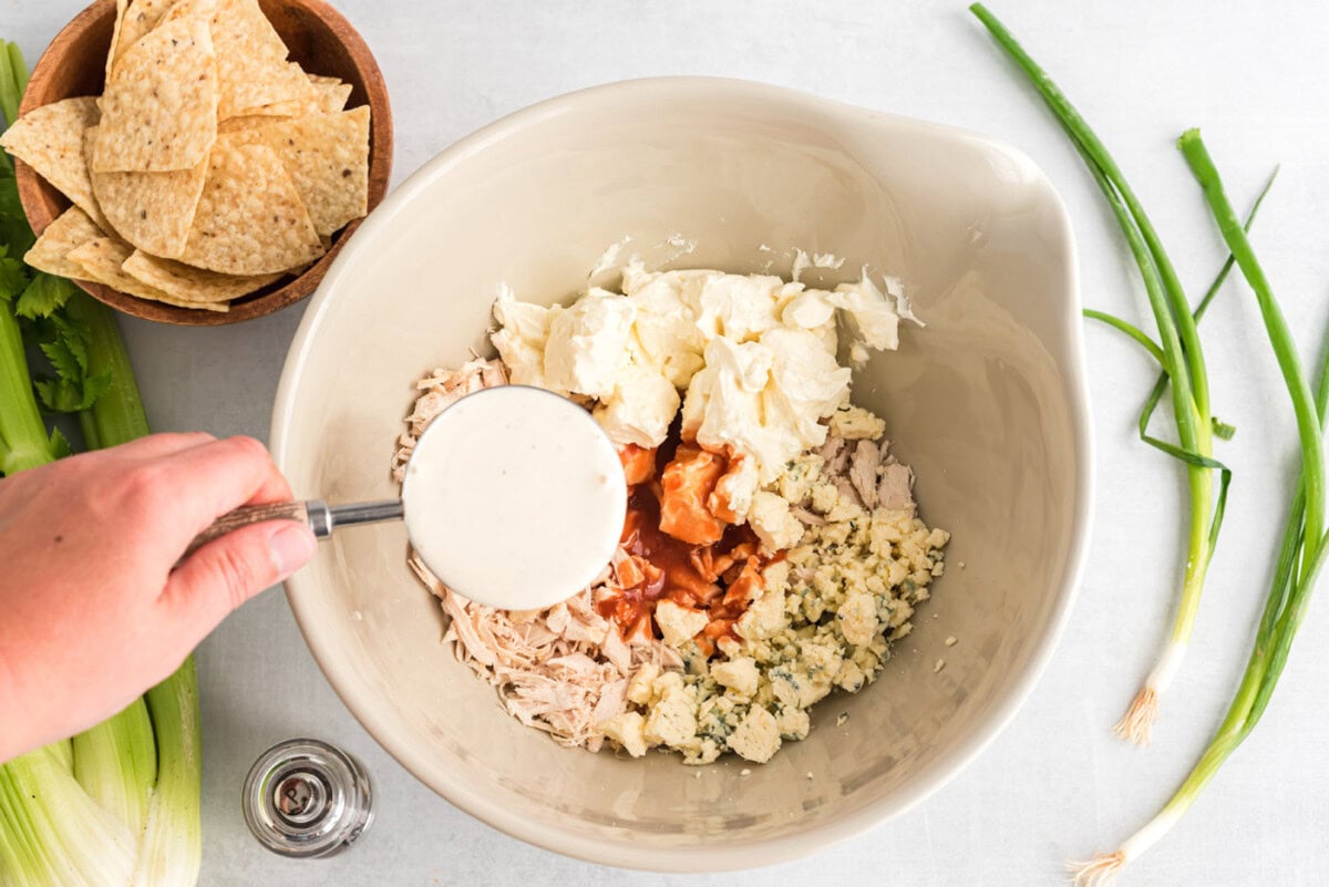 blue cheese, ranch, buffalo sauce, shredded chicken and cream cheese in a bowl