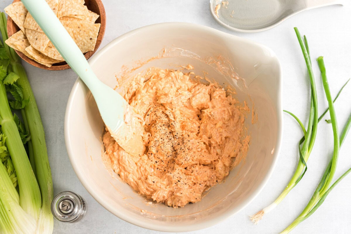 rubber spatula mixing buffalo chicken dip