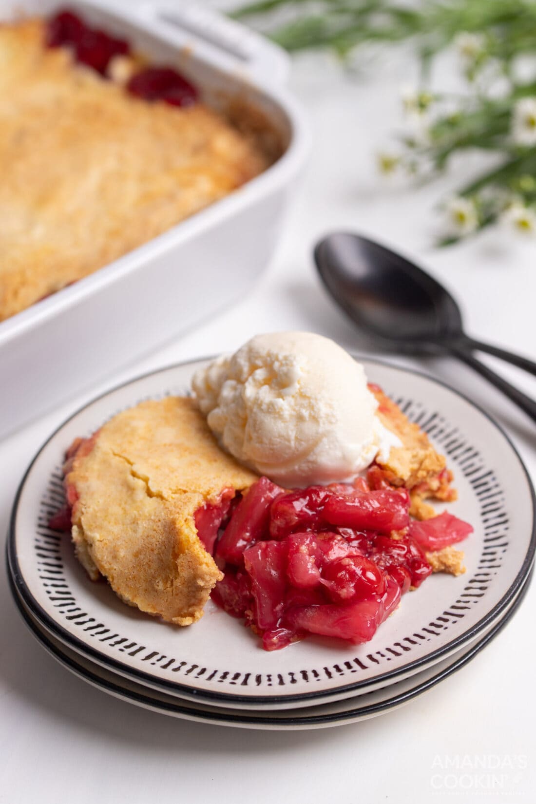 Cherry Pineapple Dump Cake on a plate with ice cream