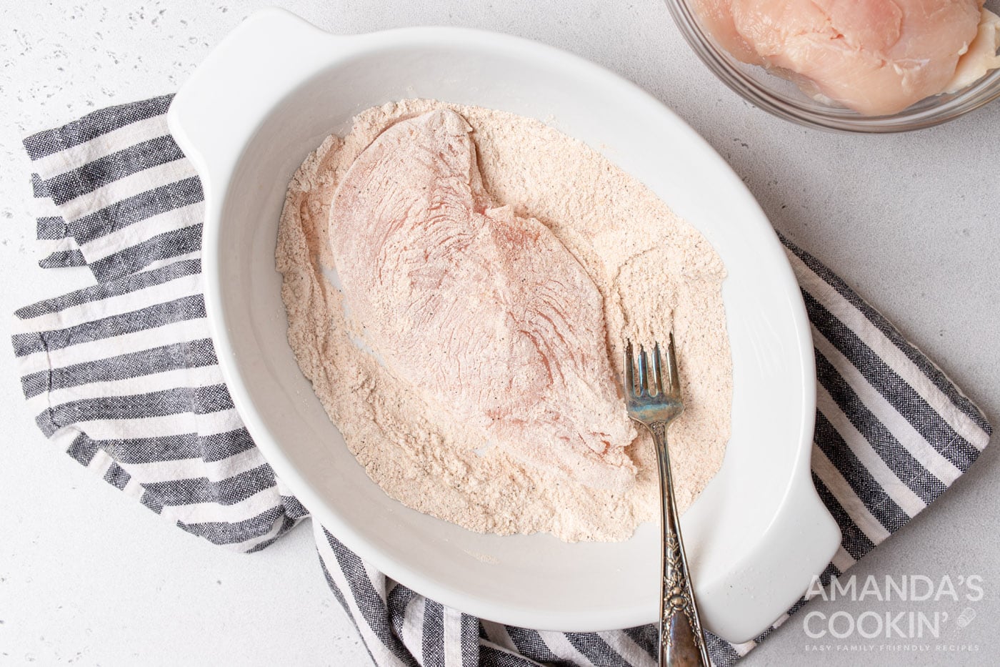 coating chicken breasts in flour mixture