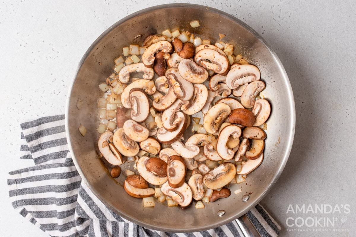 mushrooms and onions in a skillet