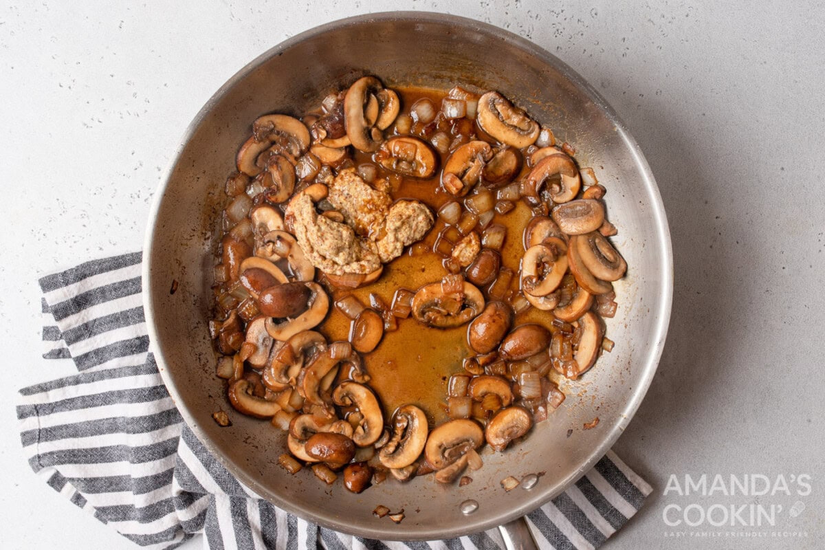 white wine with mushrooms and onions sauteed on a skillet