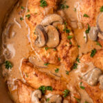 chicken in a skillet with mushrooms