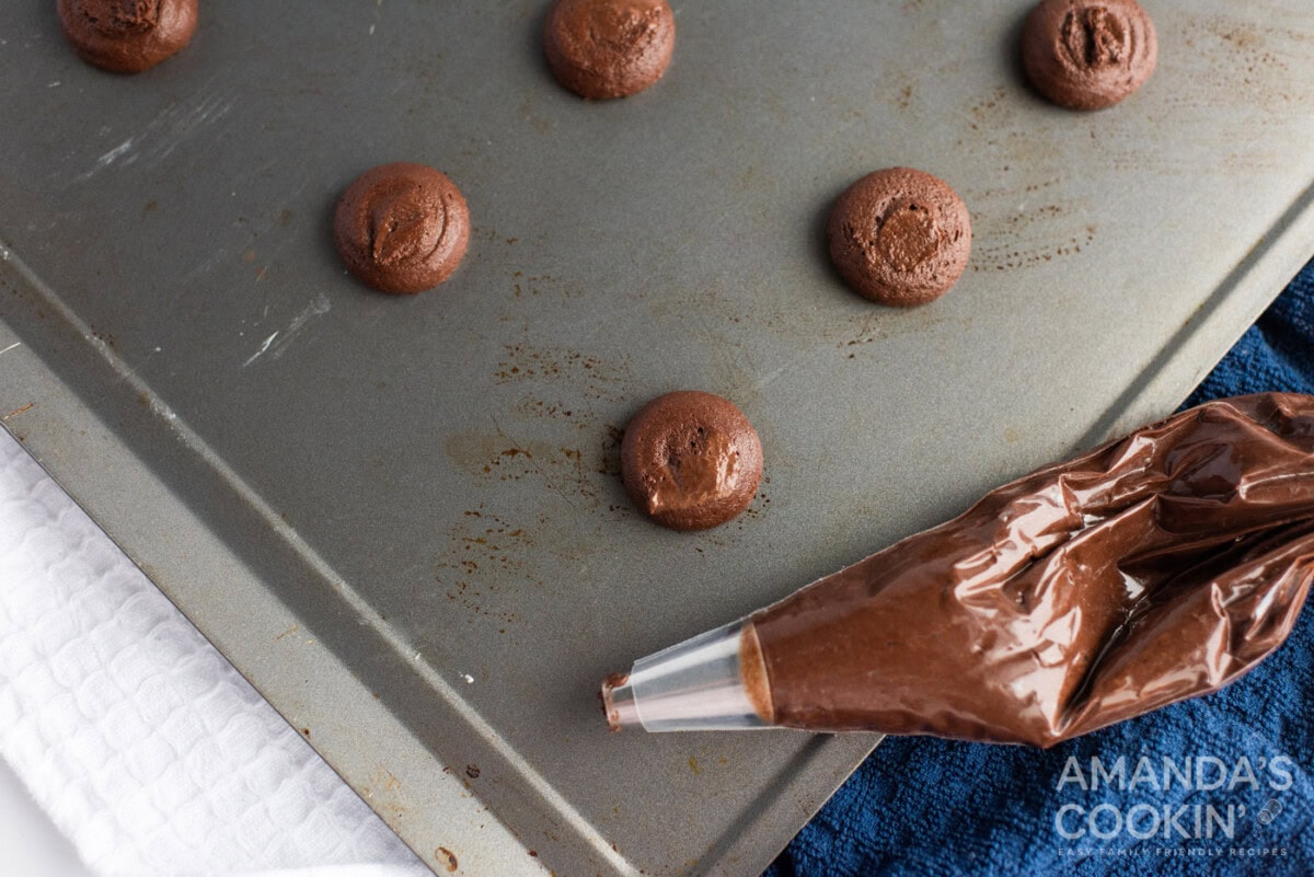 chocolate whoopie pie dough in a piping bag