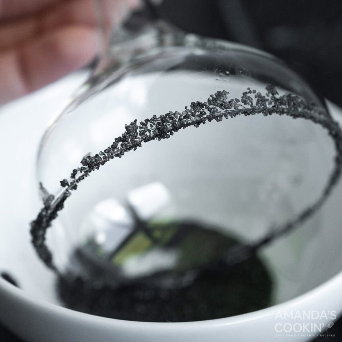 dipping margarita glass in black salt