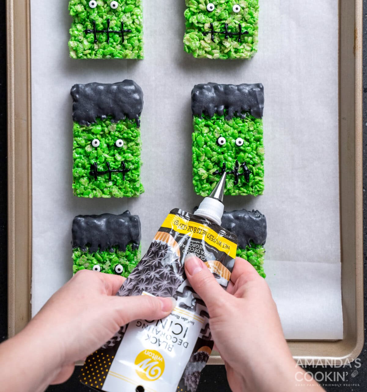 piping on frankenstein mouths to rice krispie treats