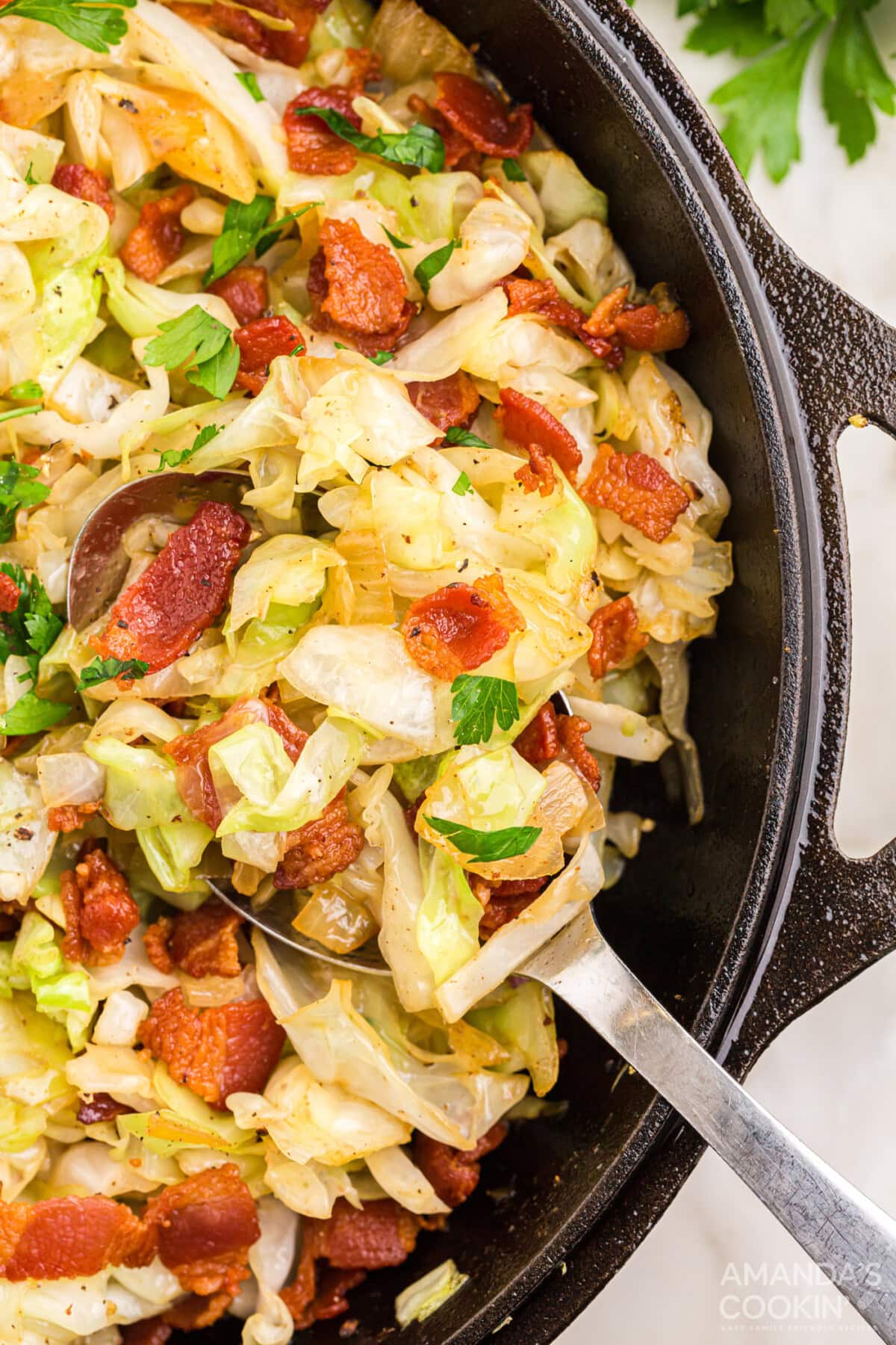 Fried Cabbage in pan with serving spoon
