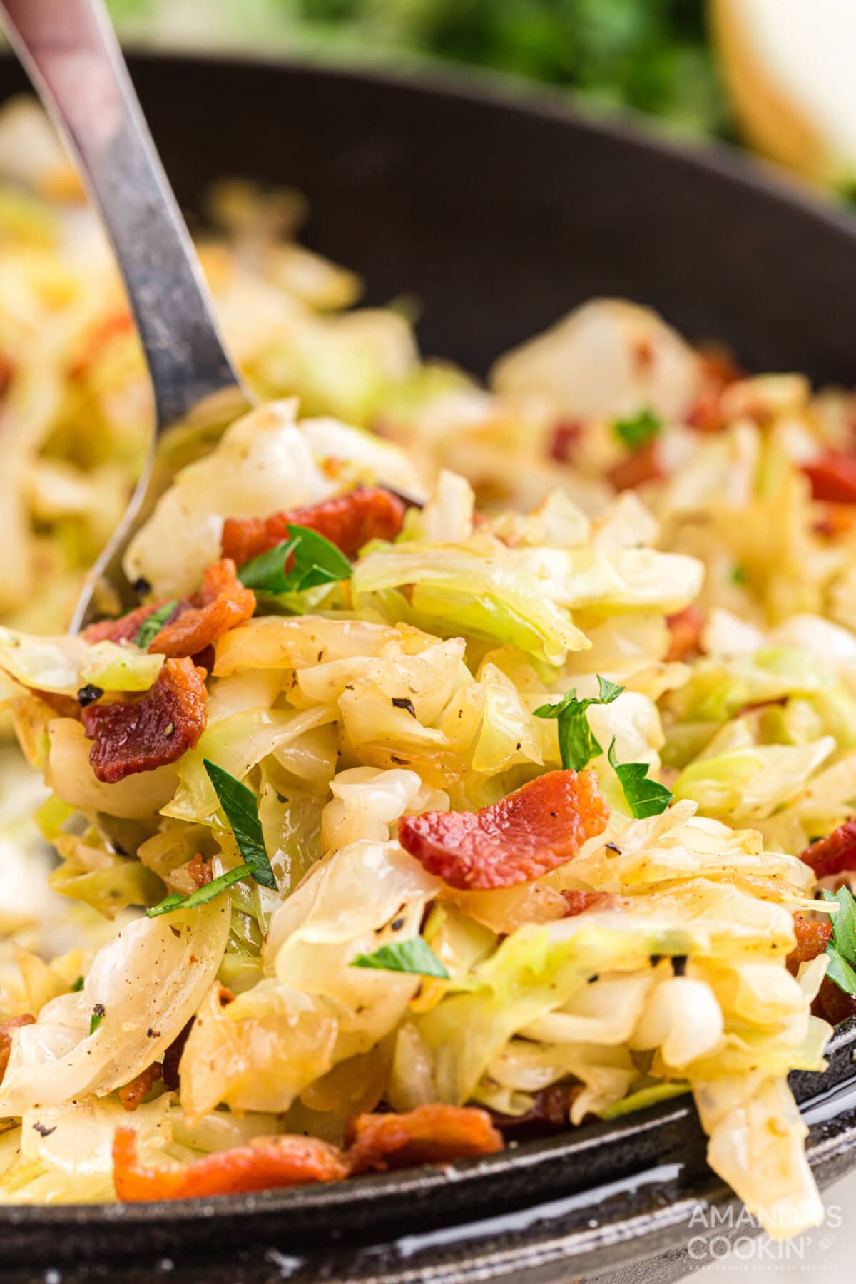 spooning out Fried Cabbage