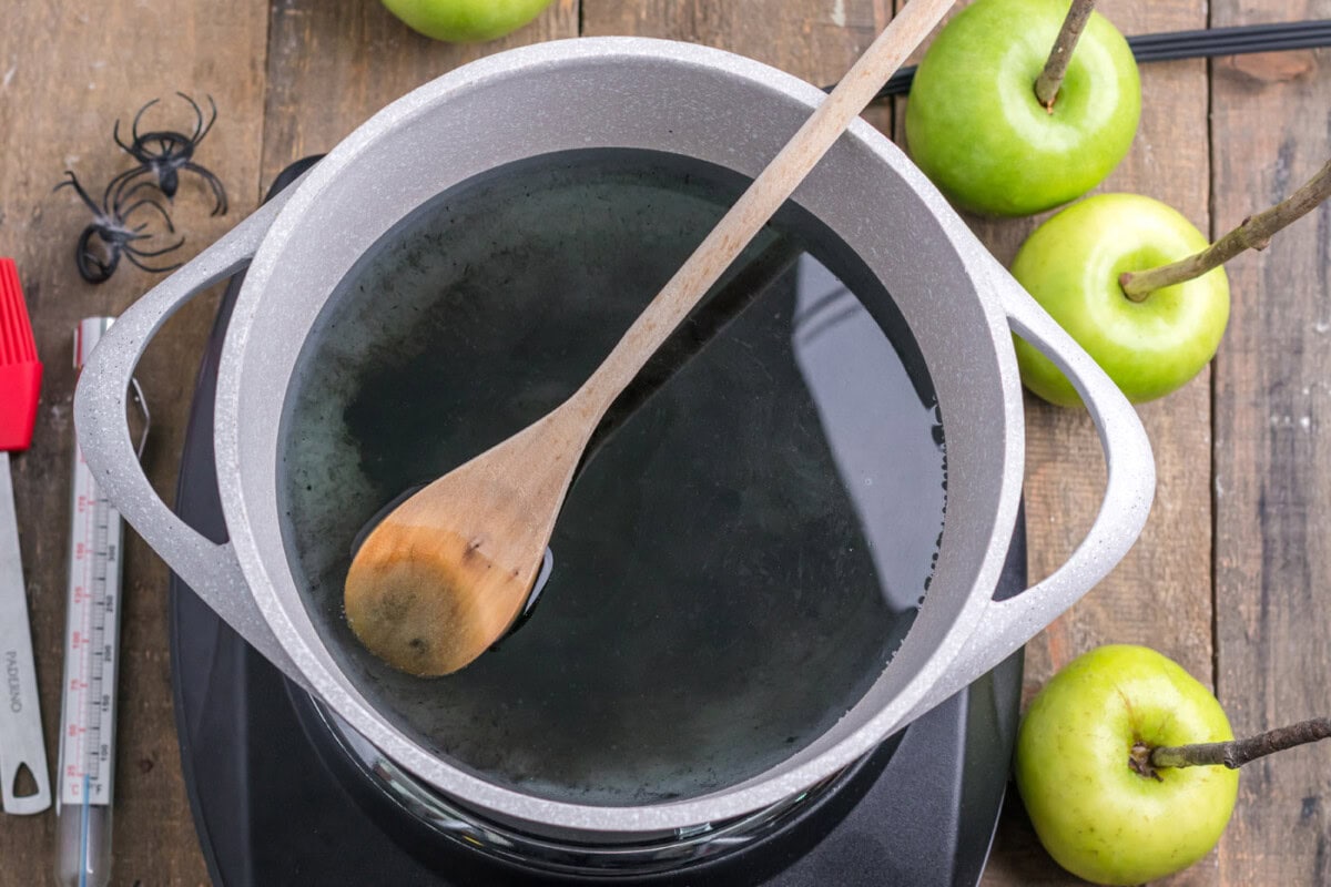 corn syrup, water, sugar, and black icing gel in a pot