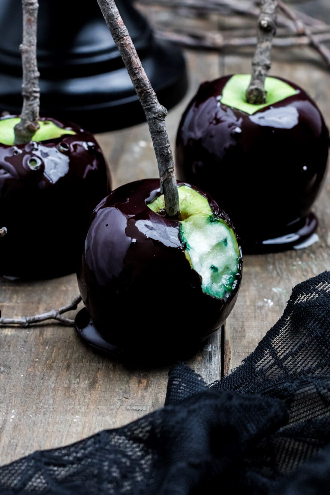 Black Halloween Caramel Apple with a bite out of it