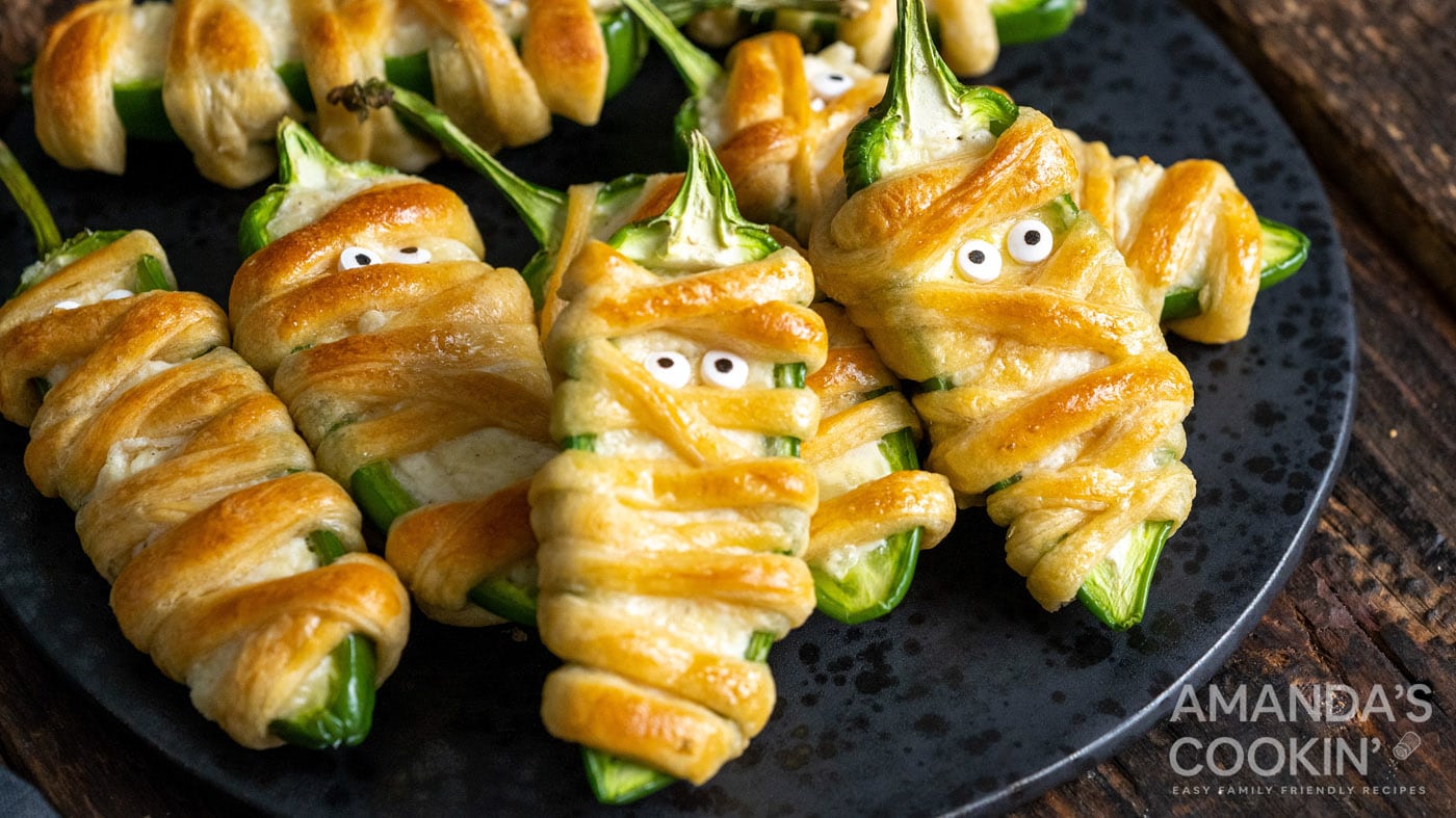 Jalapeno popper mummies are cute, spooky, and loaded with tasty ingredients. This recipe is incredib
