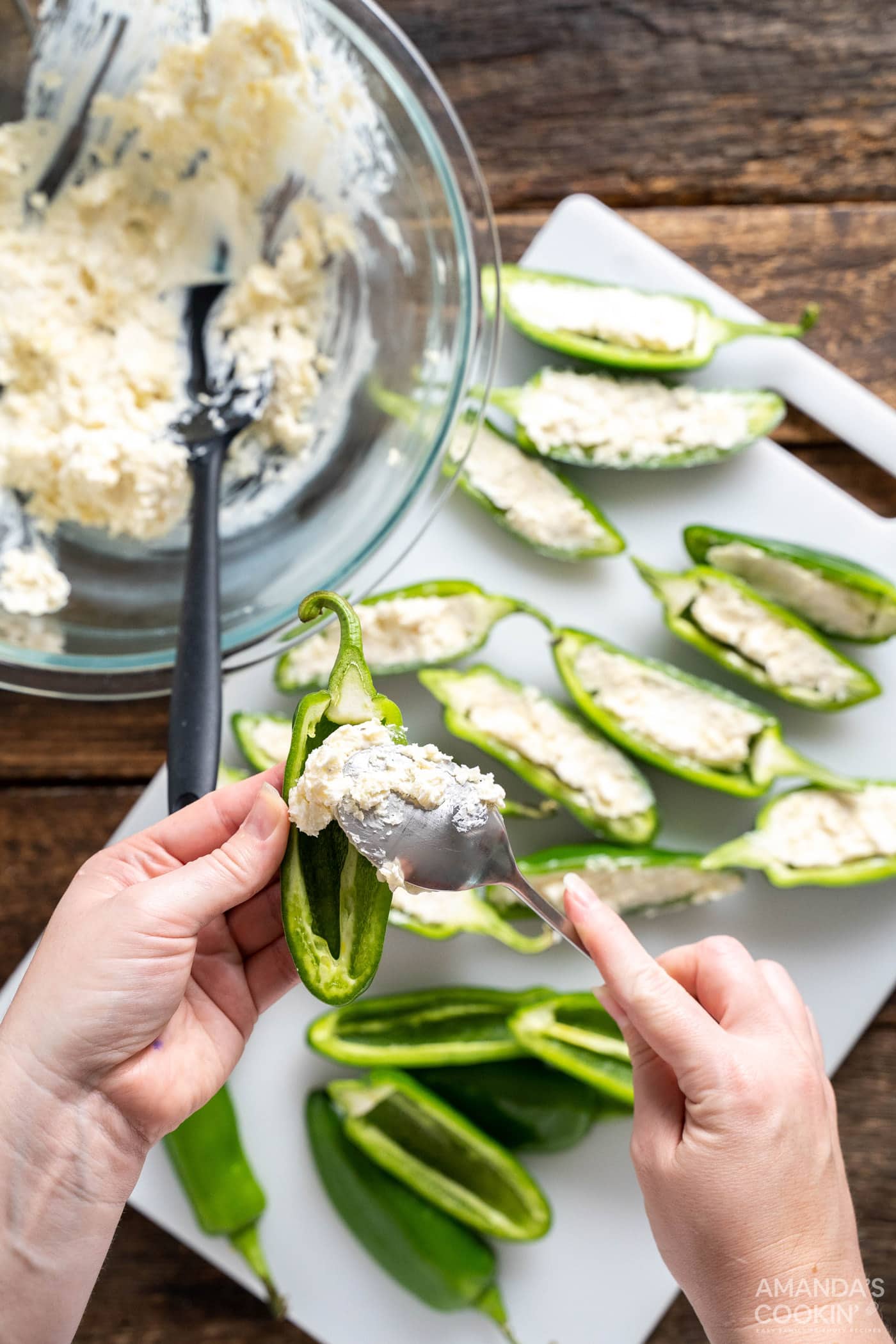 spoonful of cream cheese mixture stuffed into jalapenos