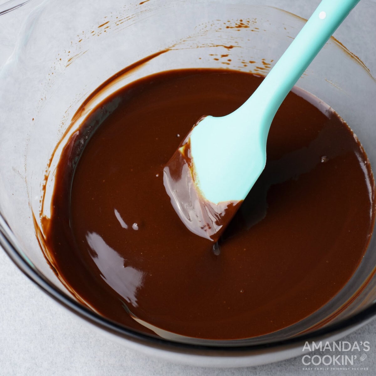 melted chocolate in a bowl with a rubber spatula