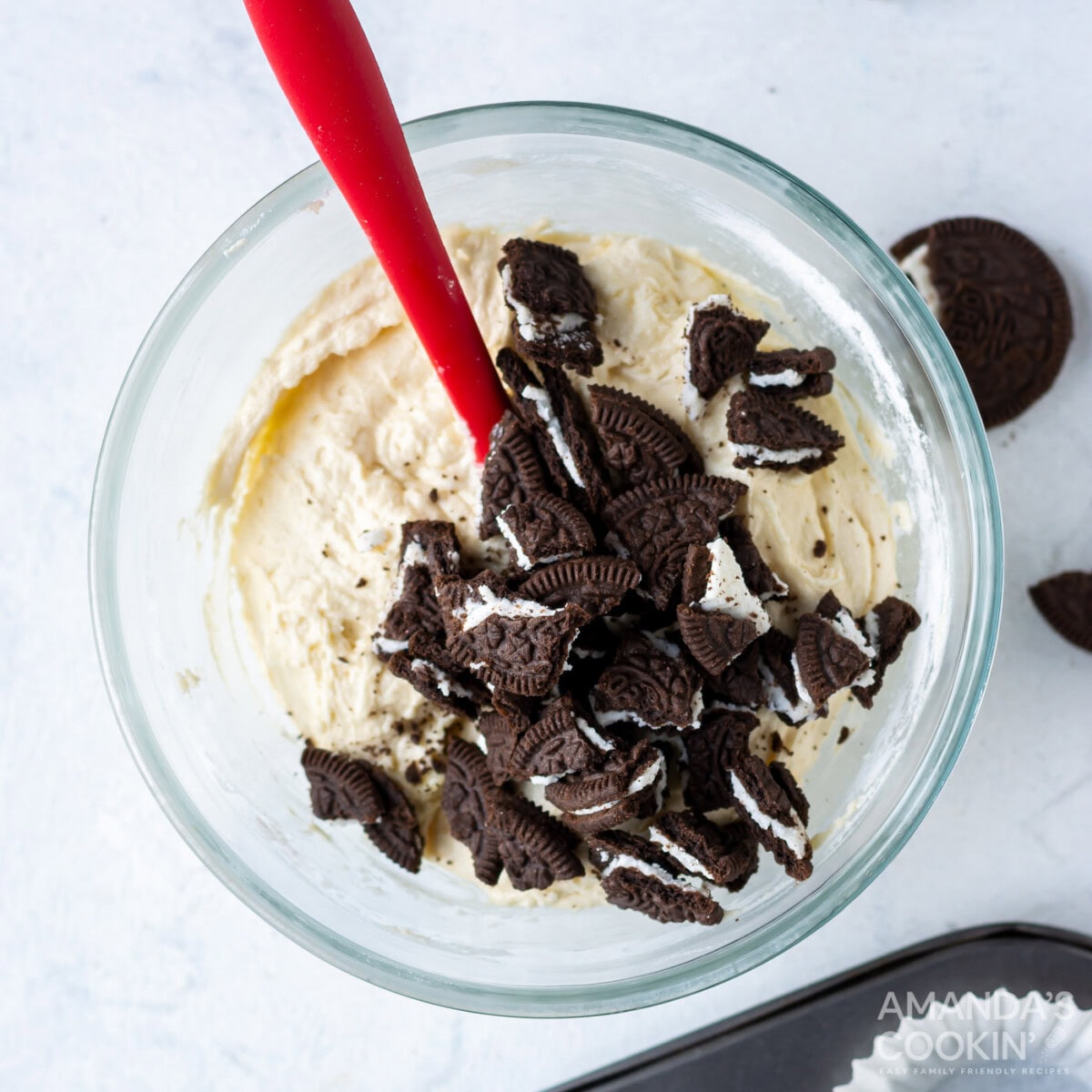 cupcake batter with crushed oreos in a mixing bowl