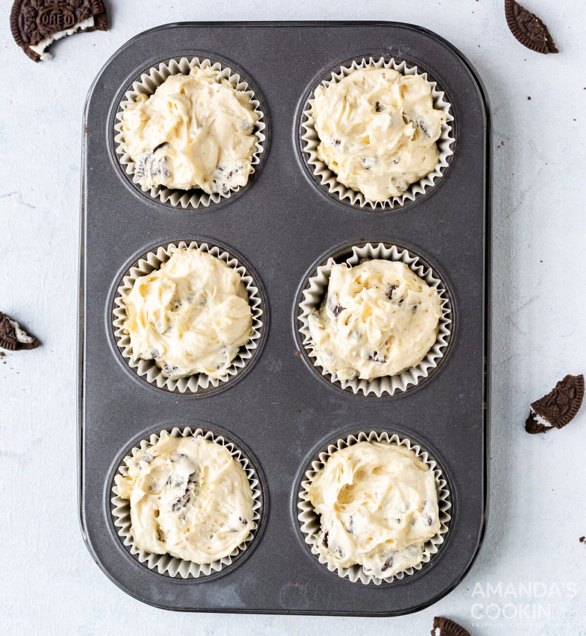 oreo cupcake batter in a cupcake tin
