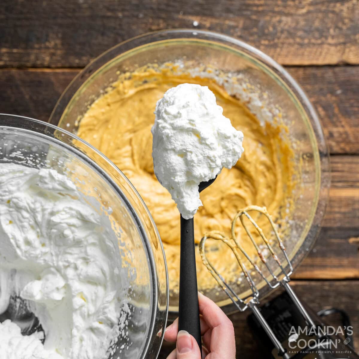 spoonful of whipped cream over cream cheese pumpkin mixture