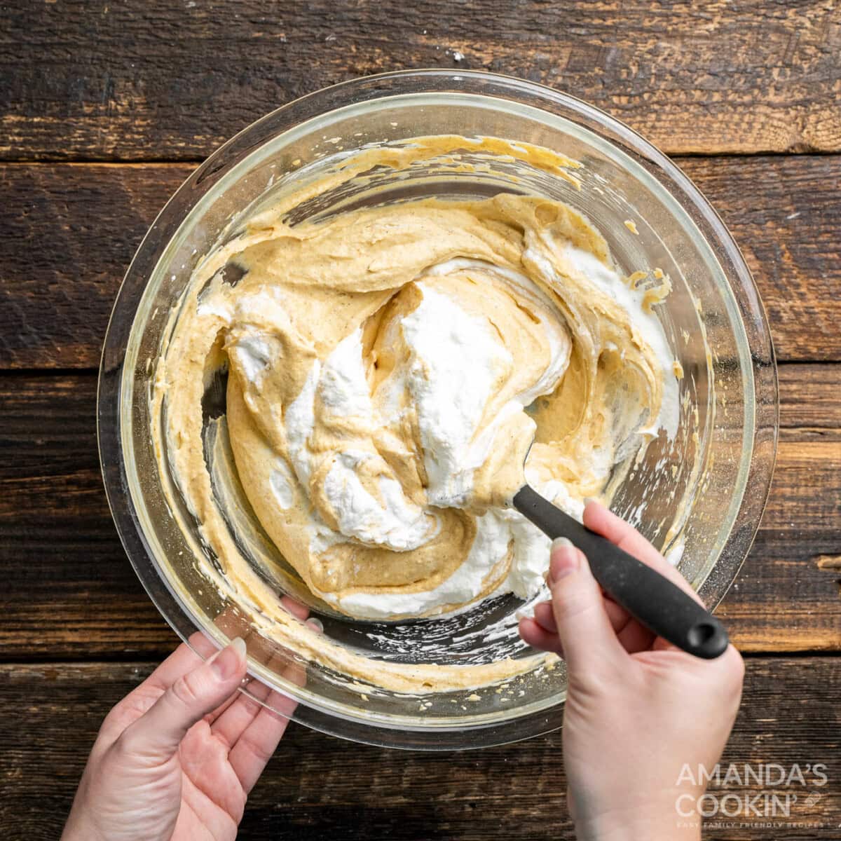 whipped cream folding into pumpkin cream cheese mixture
