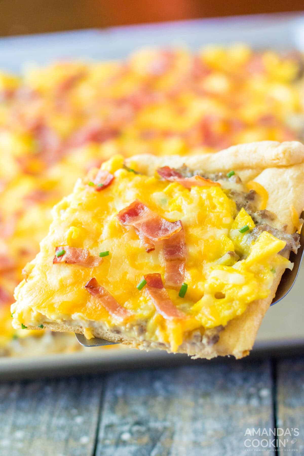 spatula lifting a piece of Sheet Pan Breakfast Pizza